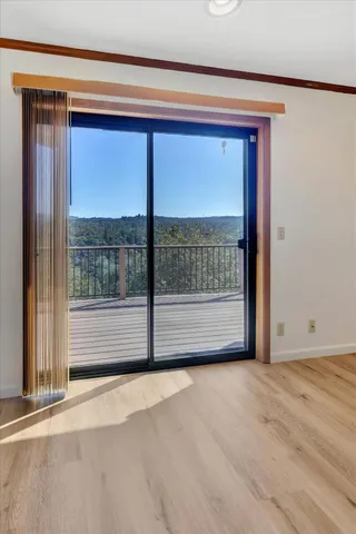 a view of empty room with floor to ceiling window
