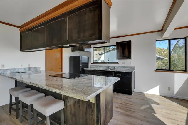 a kitchen with stainless steel appliances granite countertop a stove microwave and sink