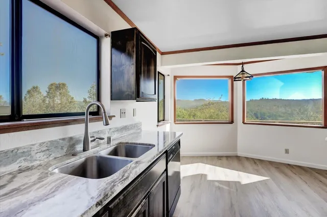 a kitchen with a sink a stove and cabinets