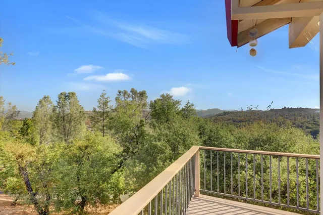 a view of a balcony with wooden fence and floor