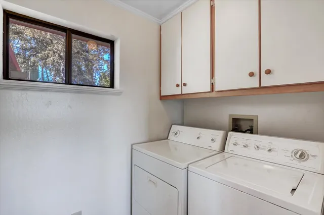 a view of storage and utility room with washer and dryer