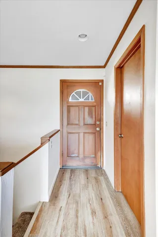 a view of front door with wooden floor