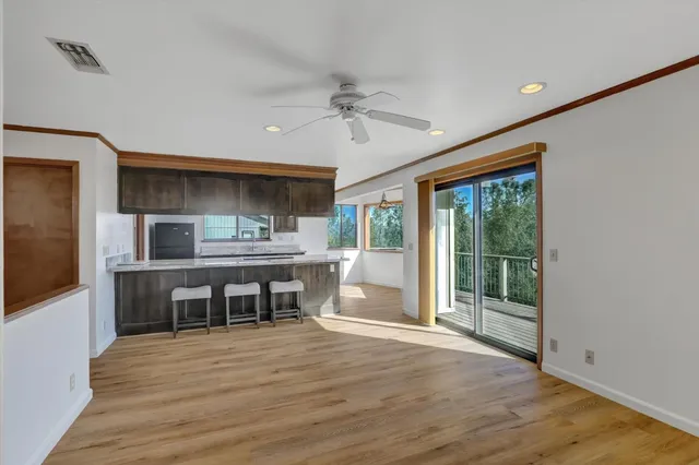 a dining room with furniture window and wooden floor
