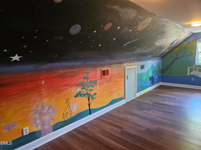 a view of a room with wooden floor