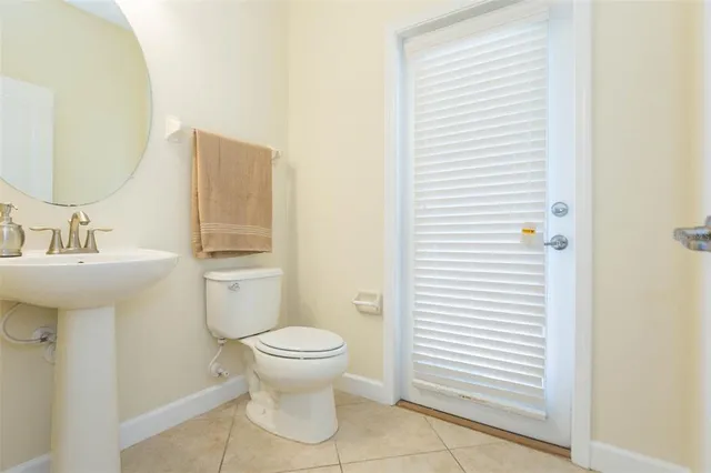 a white toilet sitting next to a bathroom sink
