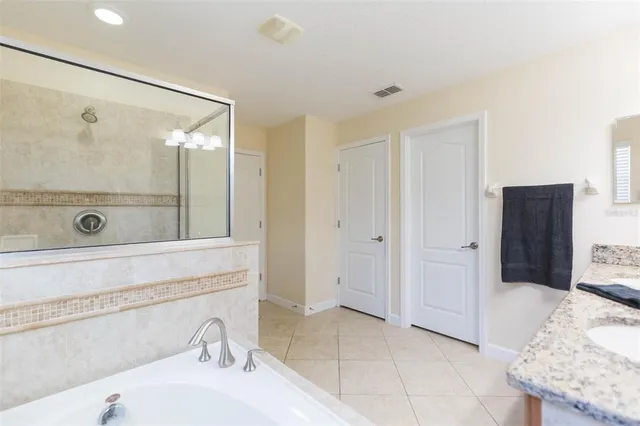 a bathroom with a tub sink and shower