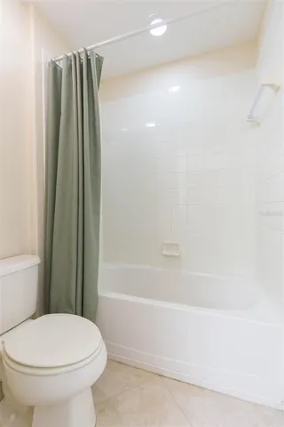 a bathroom with a toilet and a bathtub