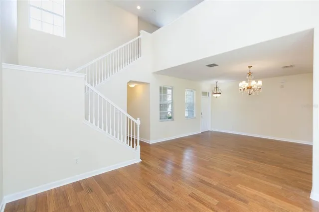 a view of a room with wooden floor and staircase