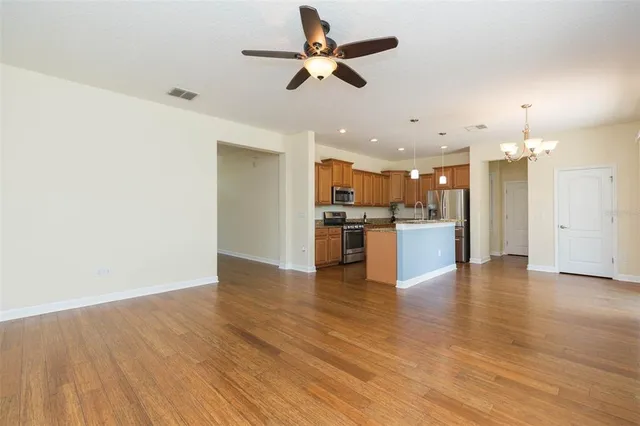 a view of kitchen with stove and wooden floor