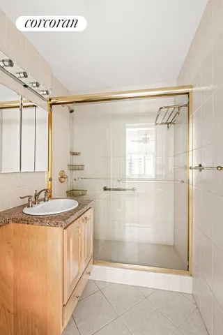 a bathroom with a sink a mirror and a shower