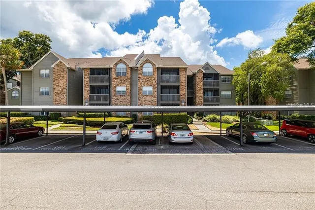 a view of a room with wooden floor and a ceiling fan
