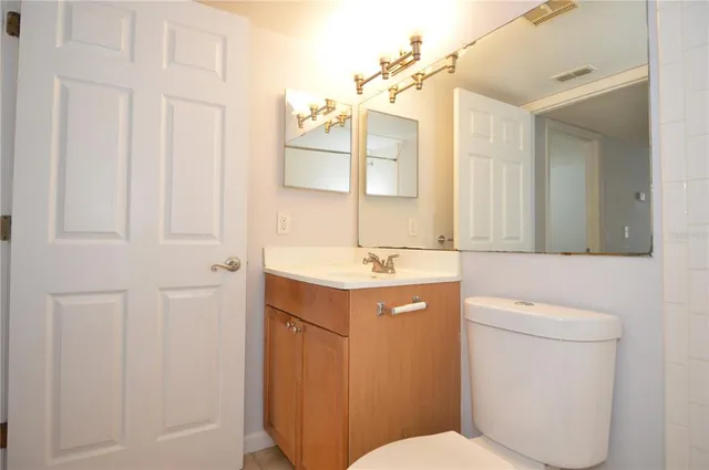 a front view of a house with a yard and fountain in middle