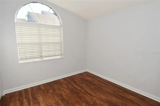 a view of a swimming pool with lawn chairs under an umbrella