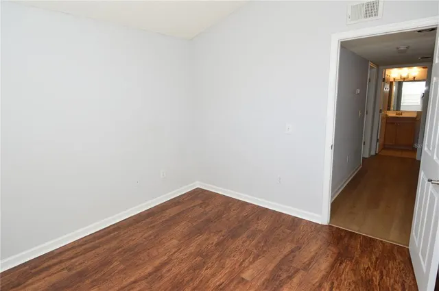 a view of a patio with a table and chairs and potted plants