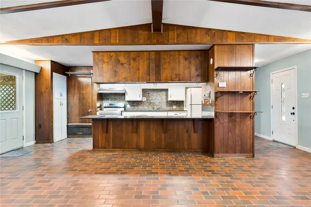 a kitchen with refrigerator and cabinets