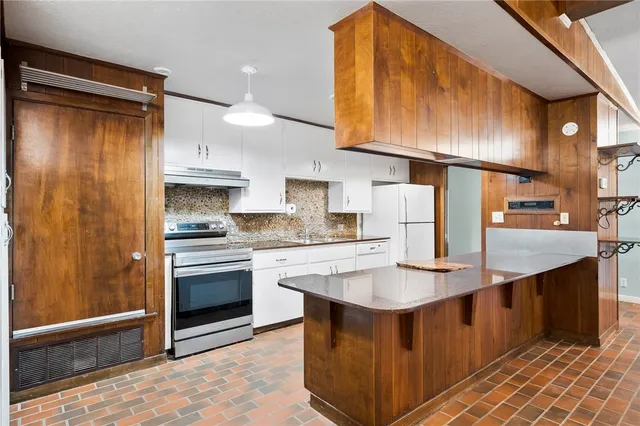 a kitchen with stainless steel appliances granite countertop a sink and cabinets