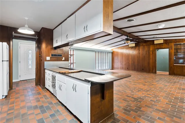 a bedroom with a bed lamp and a potted plant