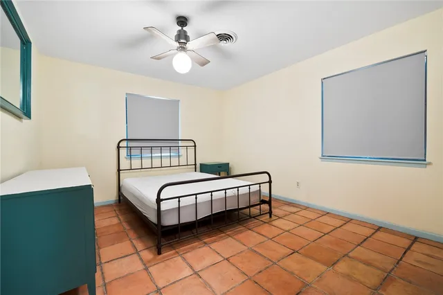 a view of a livingroom with furniture cabinet wooden floor and windows