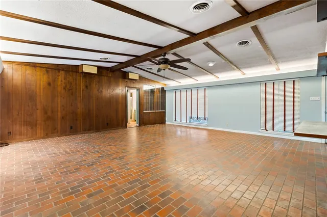 a view of a hall with kitchen and staircase