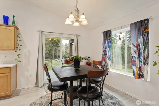 a view of a dining room with furniture wooden floor and chandelier