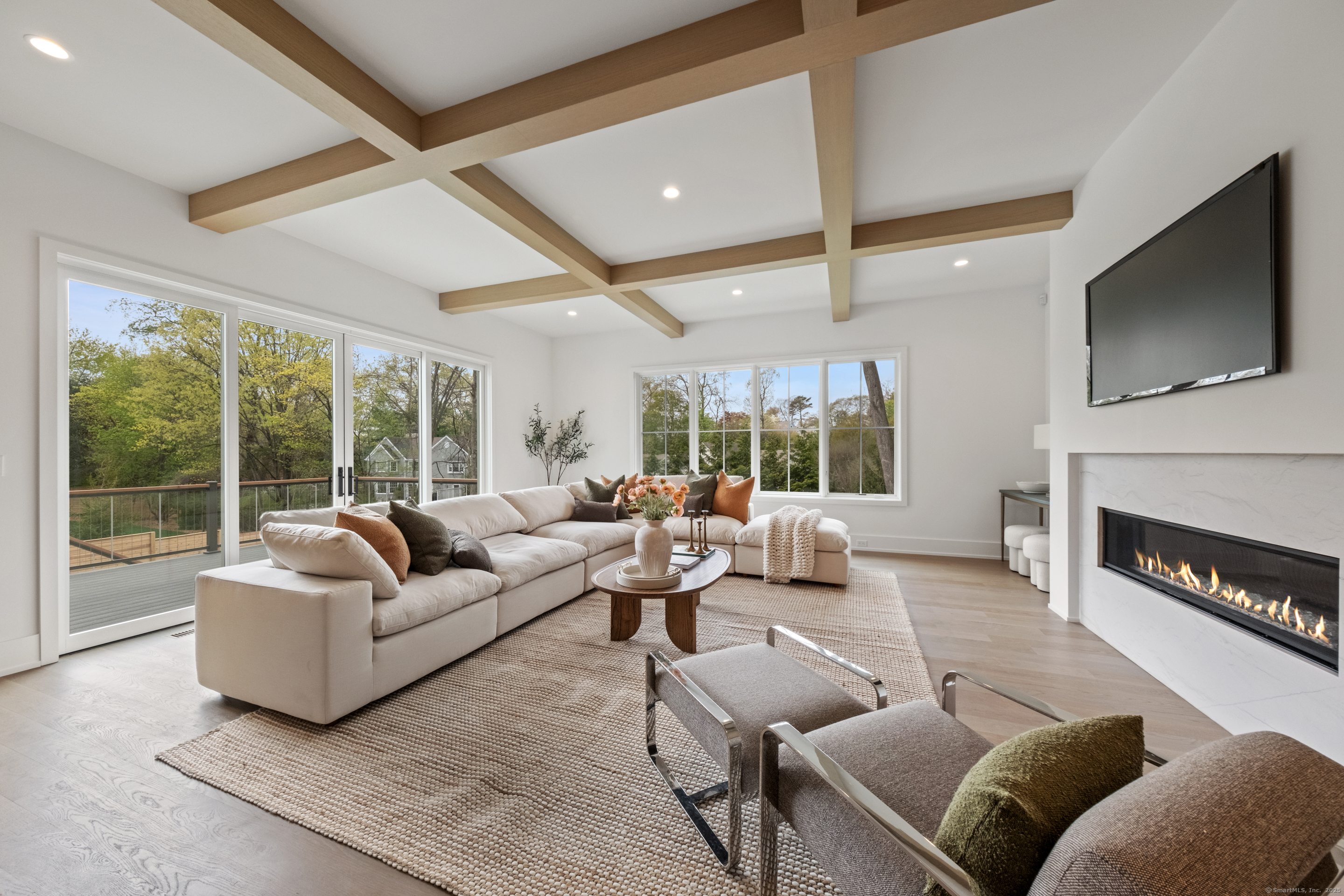 102 Compo Road South Westport, CT 06880 - Photo 13 of 40 a living room with furniture a flat screen tv and a fireplace