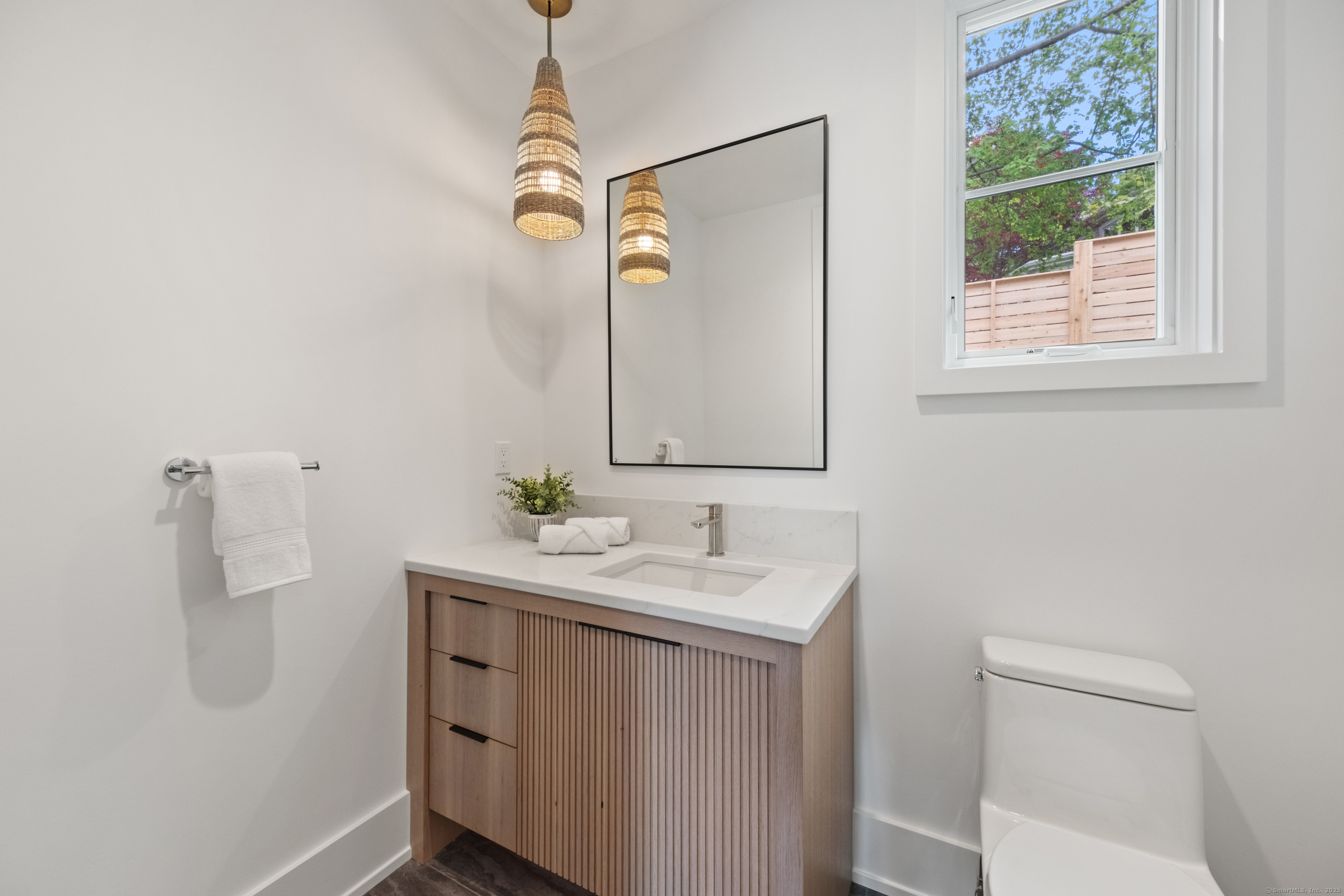 102 Compo Road South Westport, CT 06880 - Photo 17 of 40 a bathroom with a sink a mirror and a toilet