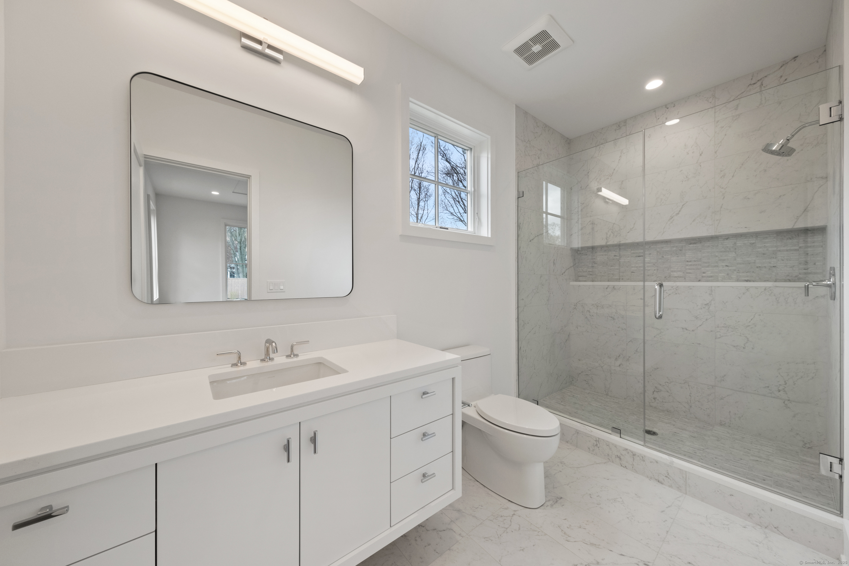 102 Compo Road South Westport, CT 06880 - Photo 27 of 40 a bathroom with a double vanity sink toilet and a mirror