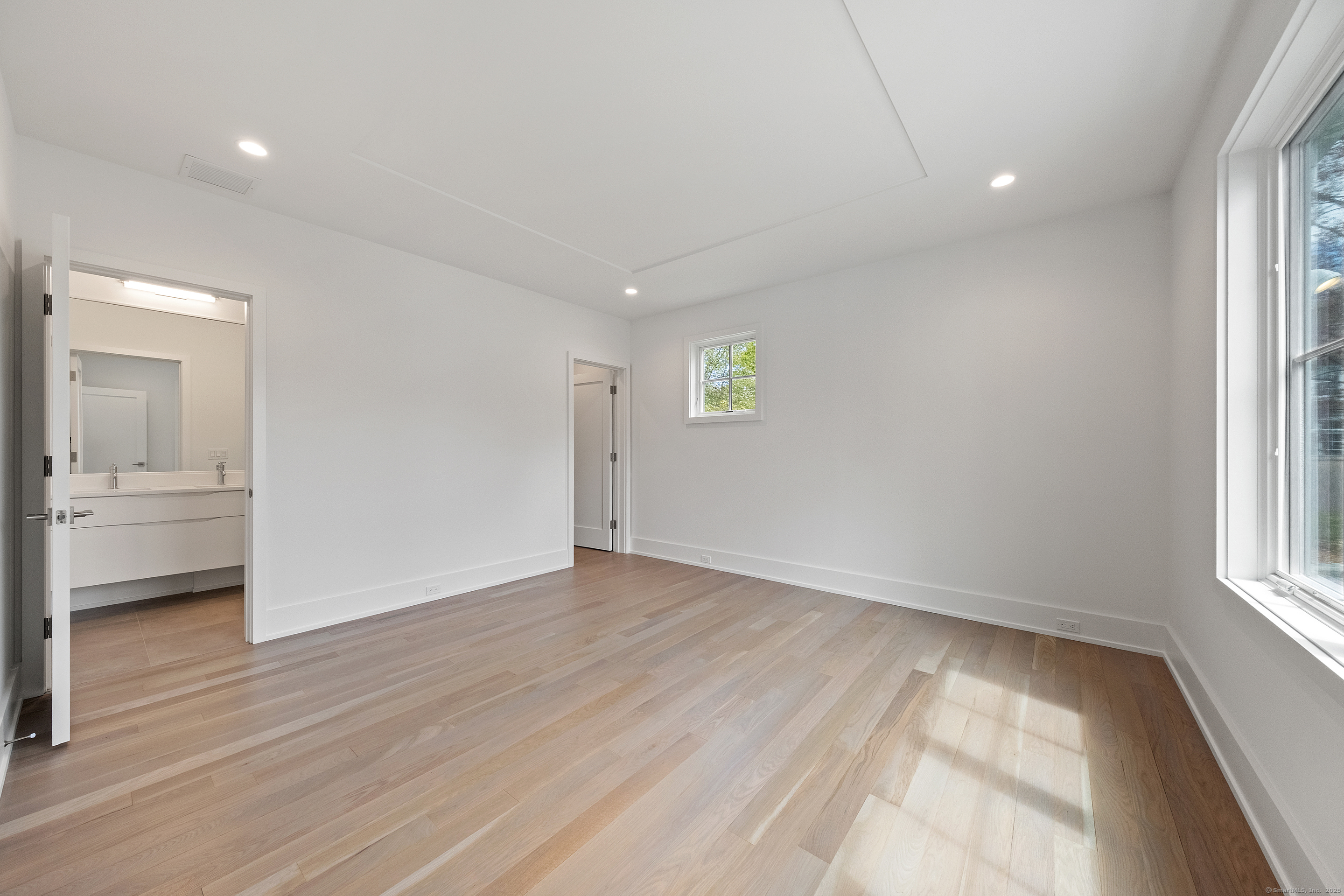 102 Compo Road South Westport, CT 06880 - Photo 28 of 40 an empty room with wooden floor and windows