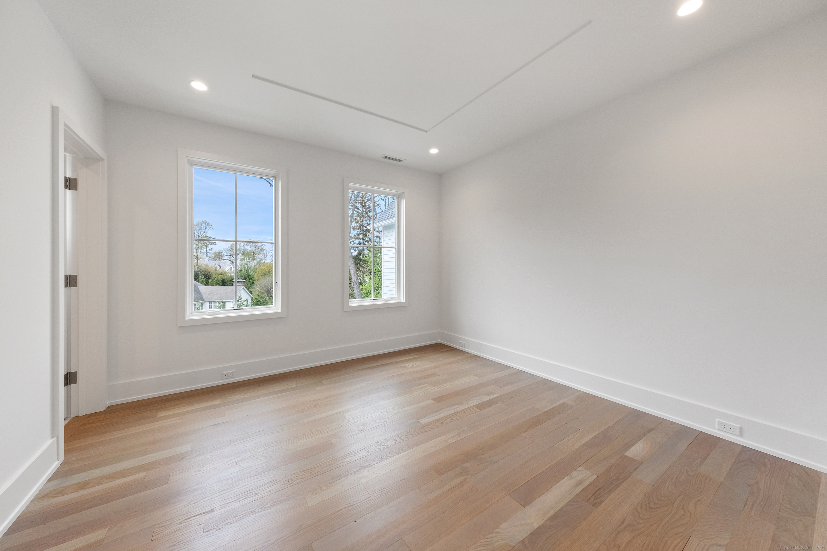 102 Compo Road South Westport, CT 06880 - Photo 30 of 40 an empty room with wooden floor and windows