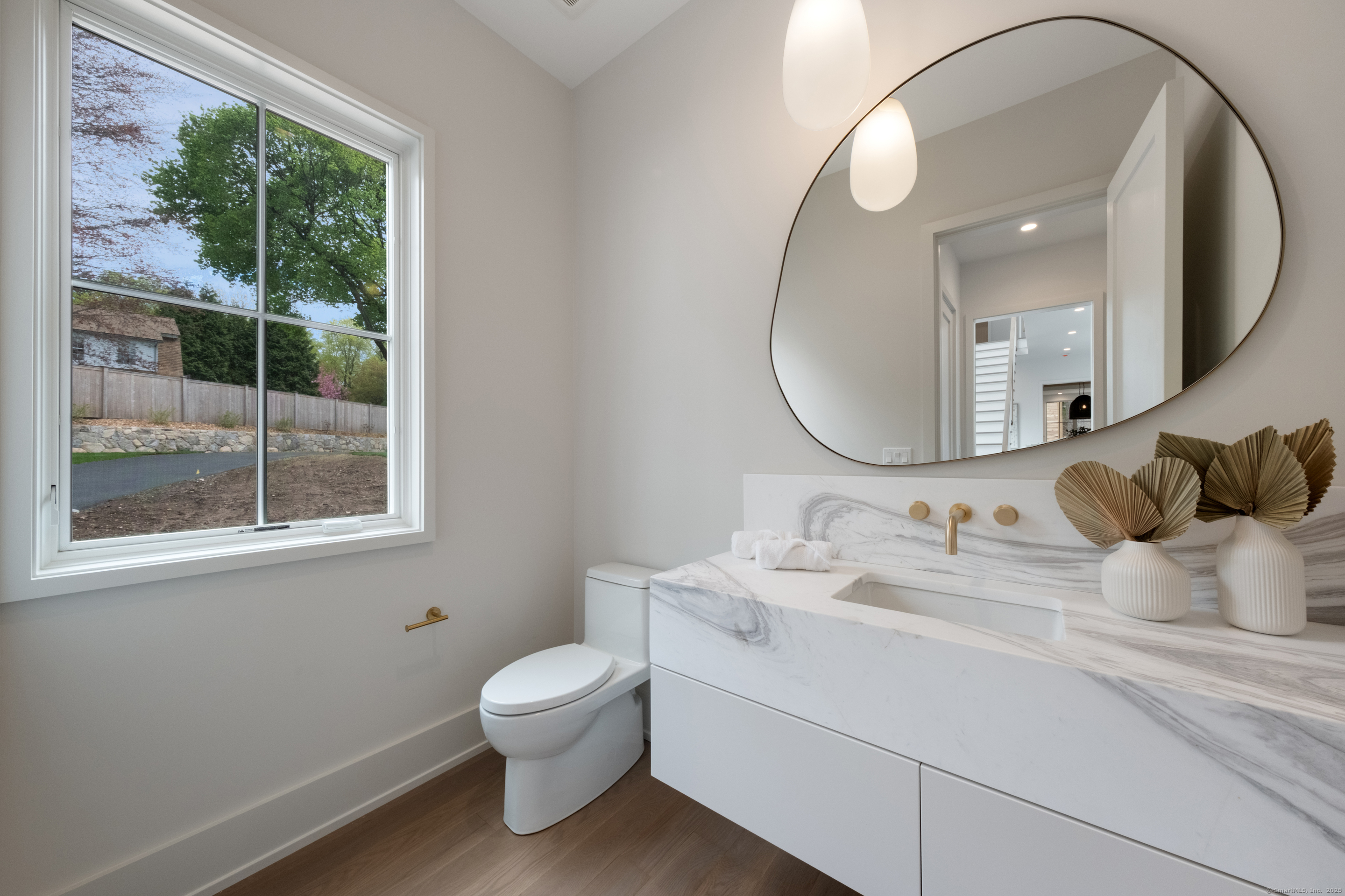 102 Compo Road South Westport, CT 06880 - Photo 38 of 40 a bathroom with a toilet sink and mirror