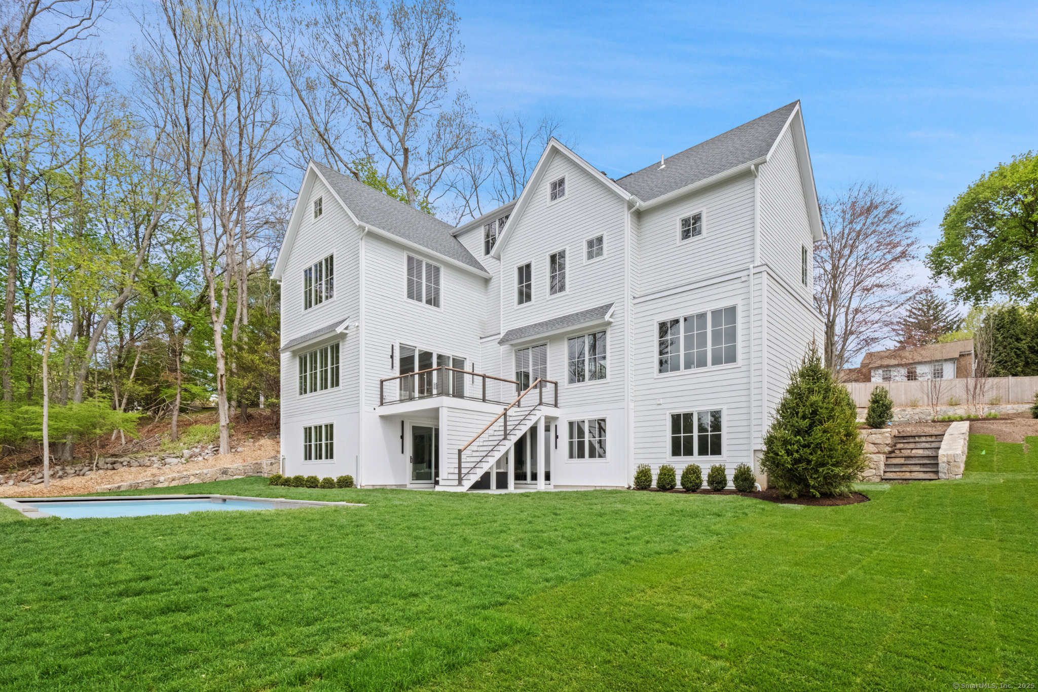 102 Compo Road South Westport, CT 06880 - Photo 39 of 40 a view of a white house next to a yard with big trees