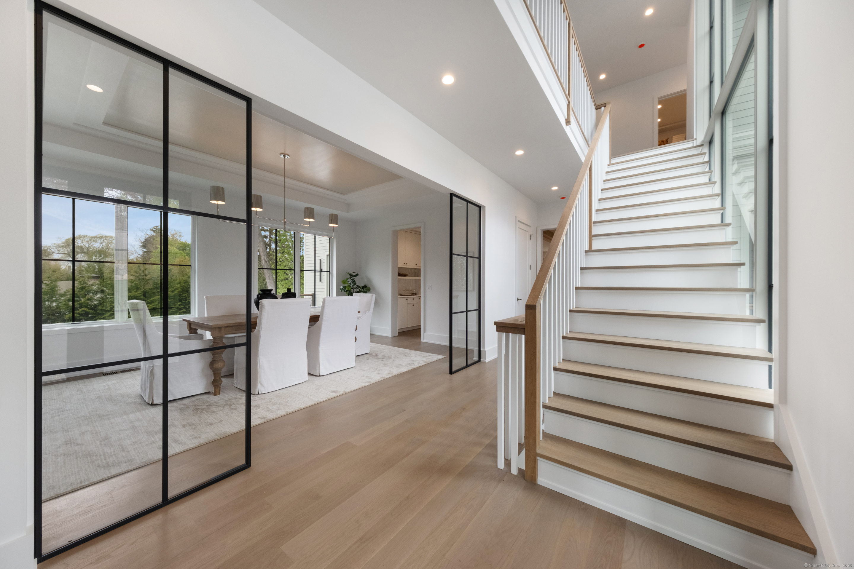 102 Compo Road South Westport, CT 06880 - Photo 4 of 40 a view of a hallway with two couches and chandelier