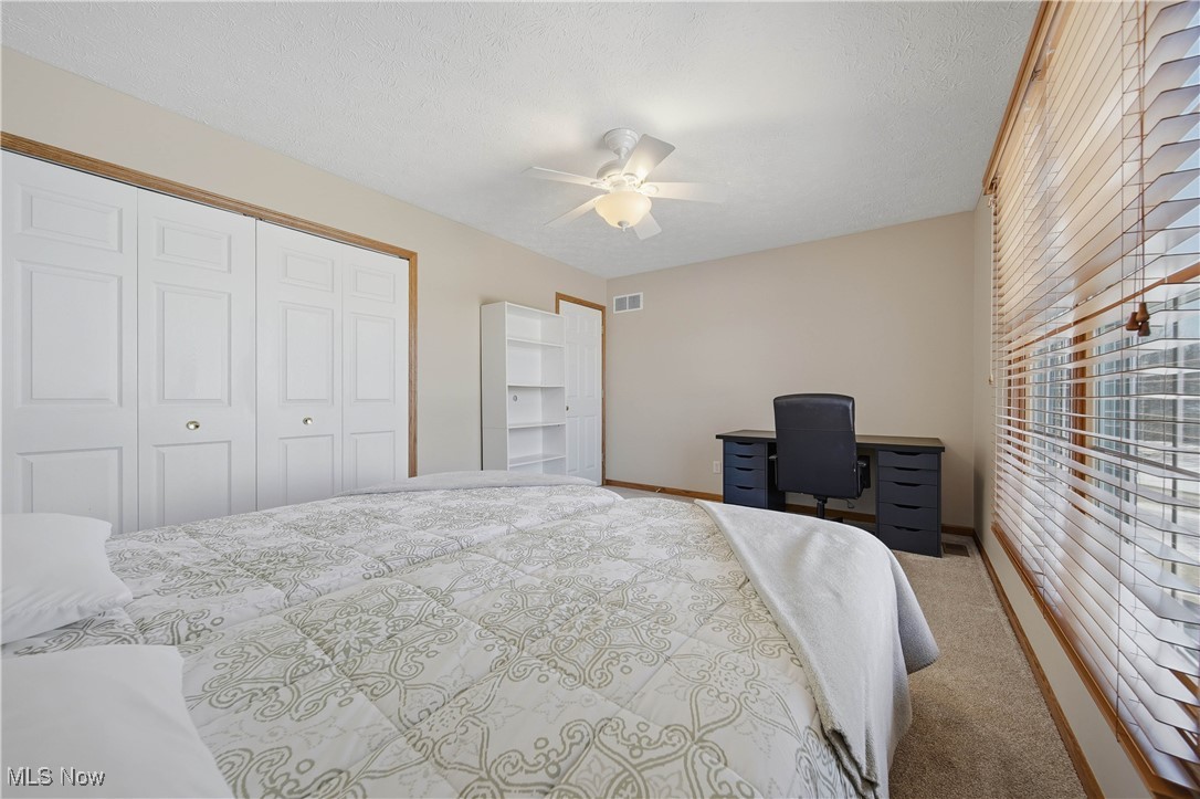 2132 Summerchase Road Northeast Canton, OH 44721 - Photo 31 of 49 Carpeted bedroom featuring ceiling fan, a closet, a textured ceiling, and an office area
