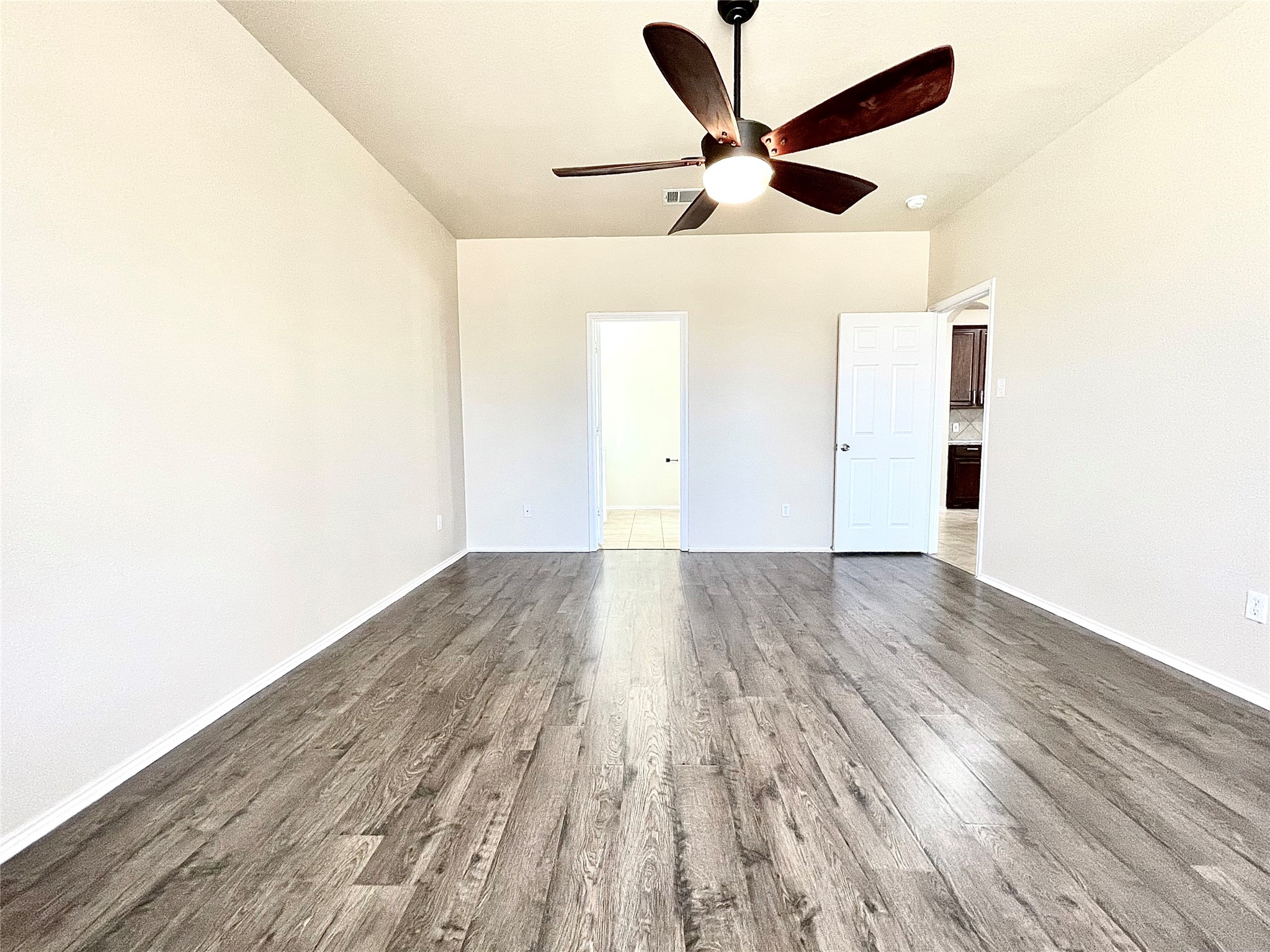 508 Emma Rose Trail Leander, TX 78641 - Photo 35 of 40 Rich wood flooring stretches across this naturally illuminated space, promising versatile living arrangements.