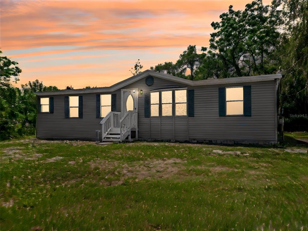 1819 Sinclair Hills Road Lutz, FL 33549 - Photo 5 of 60 a front view of a house with a garden