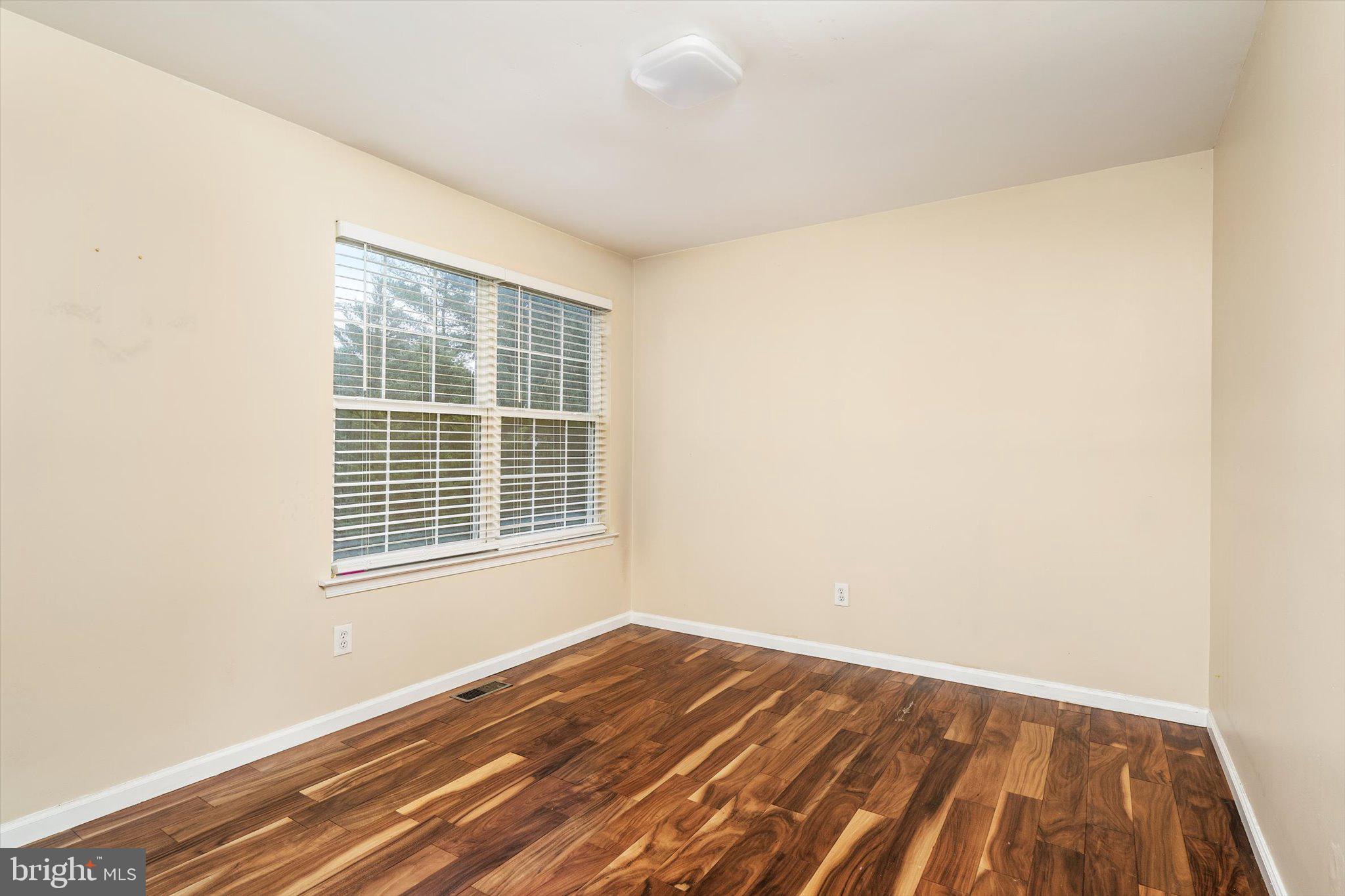 410 Denow Road Pennington, NJ 08534 - Photo 19 of 29 a view of an empty room with wooden floor and a window