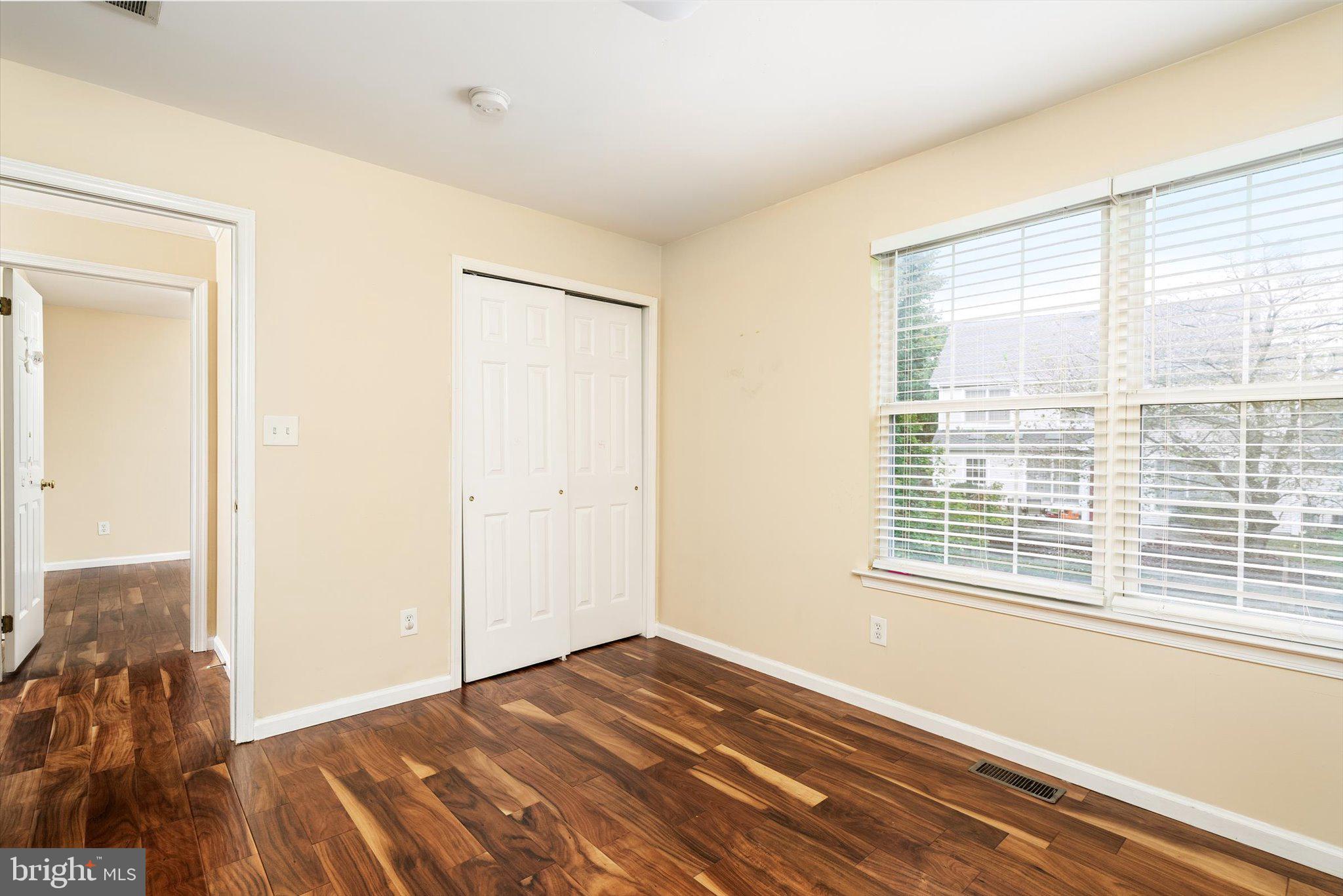 410 Denow Road Pennington, NJ 08534 - Photo 20 of 29 a view of an empty room with wooden floor and a window