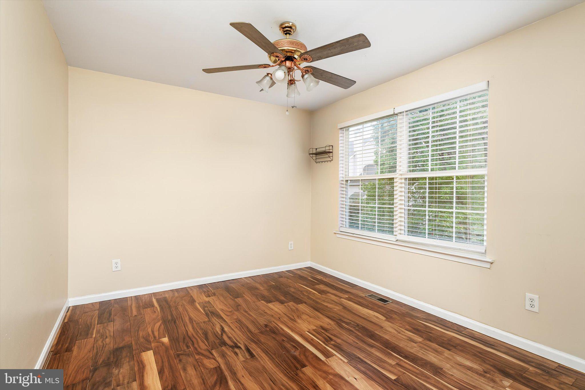 410 Denow Road Pennington, NJ 08534 - Photo 21 of 29 a view of an empty room with wooden floor and a window