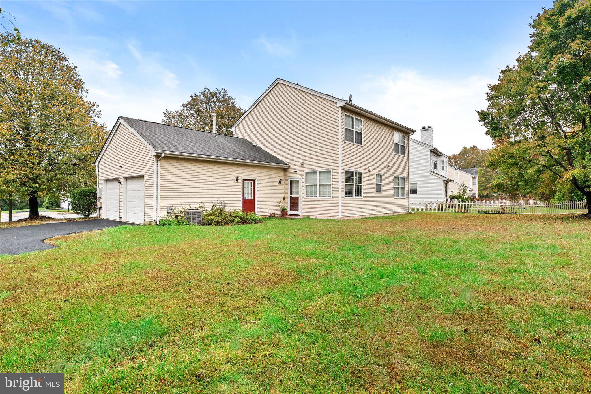 410 Denow Road Pennington, NJ 08534 - Photo 28 of 29 a view of a white house with a big yard and large trees