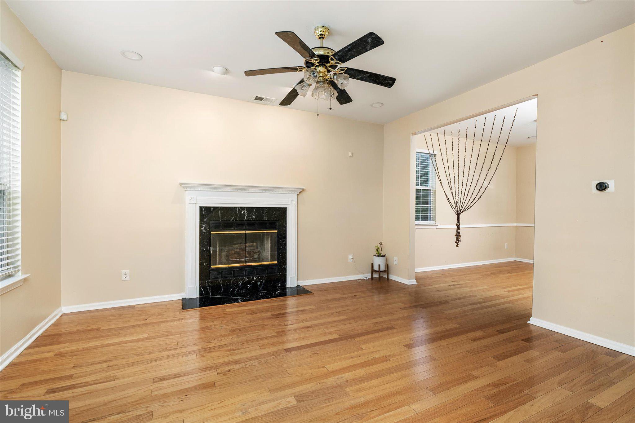 410 Denow Road Pennington, NJ 08534 - Photo 7 of 29 an empty room with wooden floor fan and windows