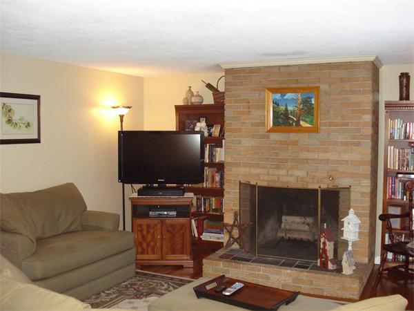 499 Worcester Road Barre, MA 01005 - Photo 7 of 13 a living room with furniture a flat screen tv and a fireplace