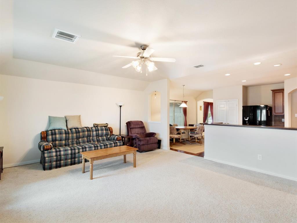 5440 Lavaca Road Grand Prairie, TX 75052 - Photo 16 of 22 Recessed lighting, ceiling fan, arched doorways, white walls, and a partial wall with a dark countertop