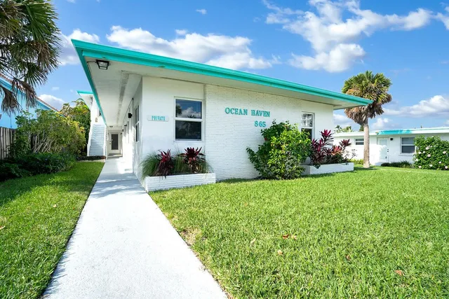 a front view of house with a garden