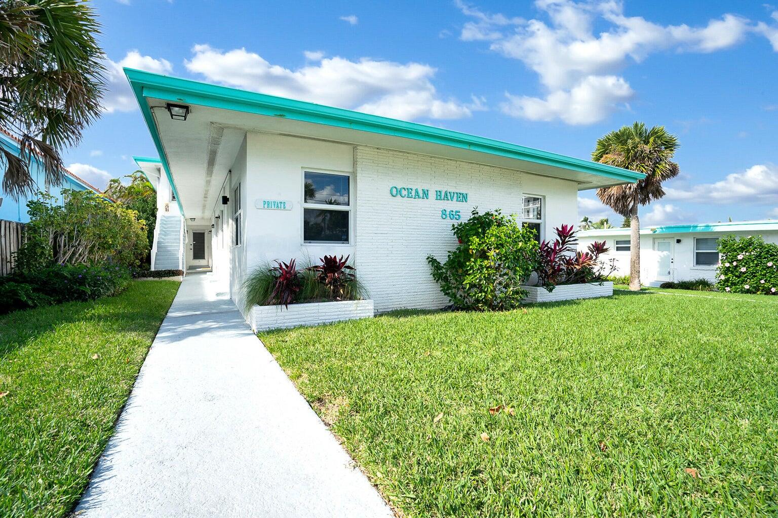a front view of house with a garden