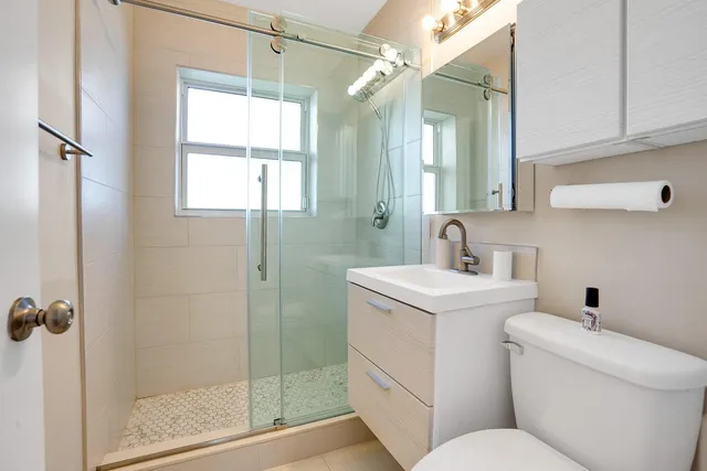 a bathroom with a sink toilet and shower