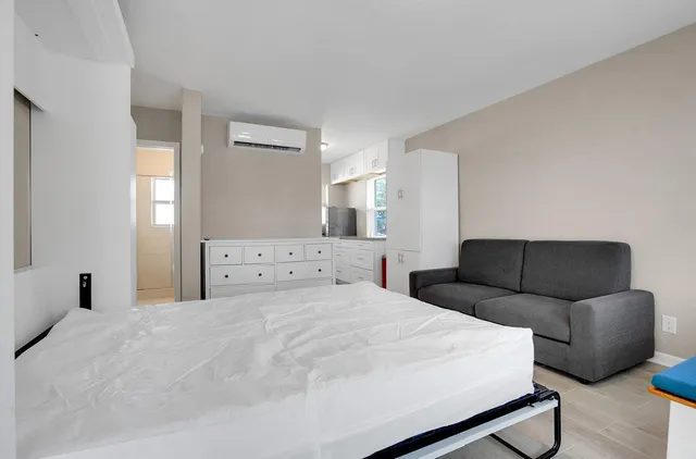 a bedroom with a bed and a couch