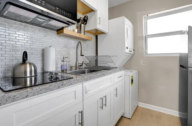 a kitchen with cabinets and window