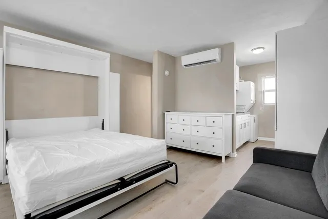 a bedroom with a bed and a couch