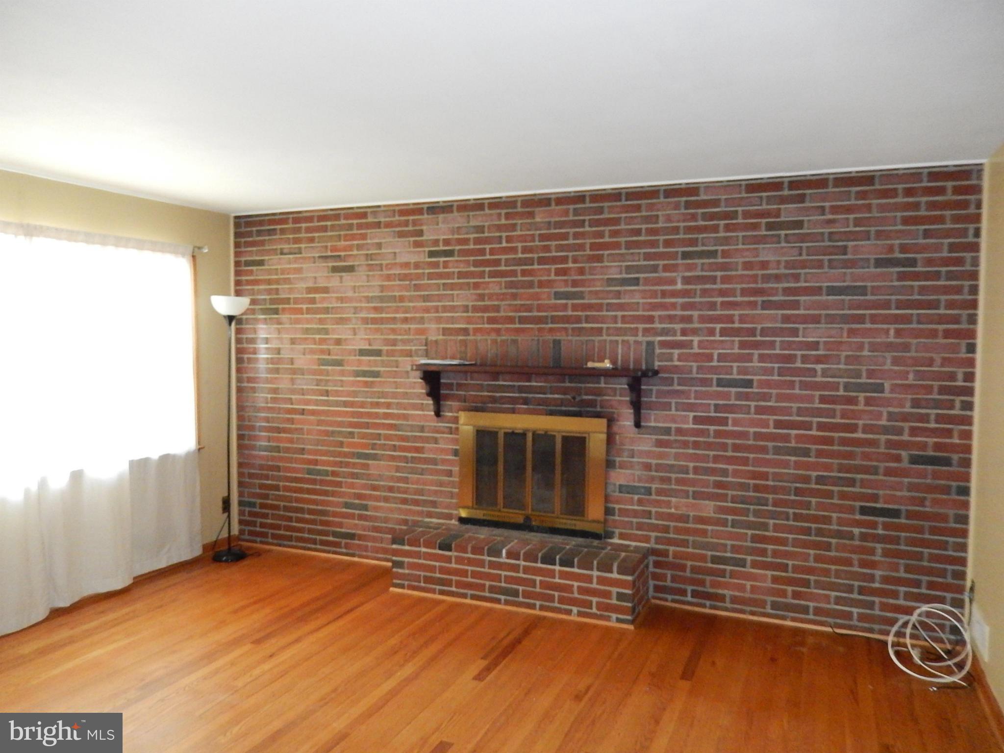537 Hawthorne Road Linthicum Heights, MD 21090 - Photo 11 of 16 Living Room with wood burning fireplace