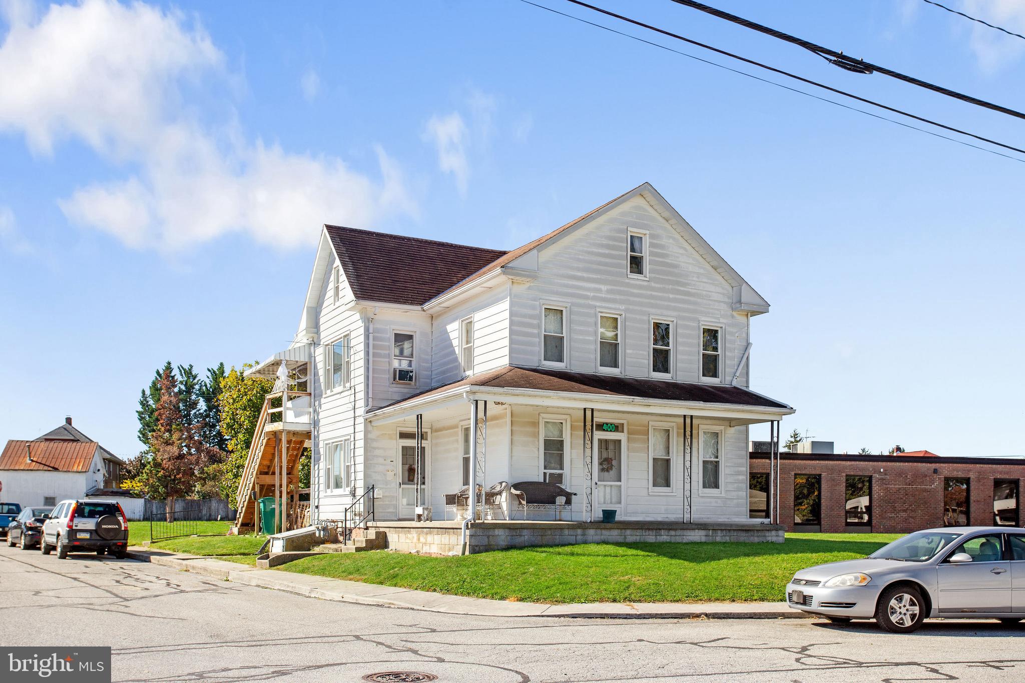 a car parked in front of a white building